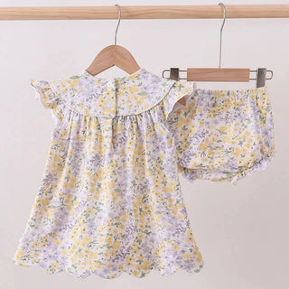 Floral baby outfit with top and shorts on a hanger against a white background