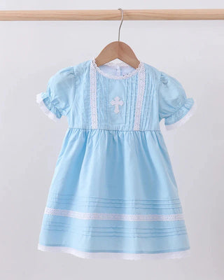 Light blue dress with white trim on a wooden hanger against a light gray background