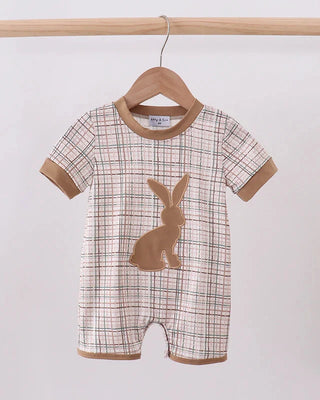 Baby romper with plaid pattern and bunny design on a hanger against a white background