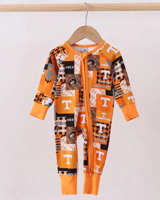 Orange and black patterned baby onesie on a hanger against a white background