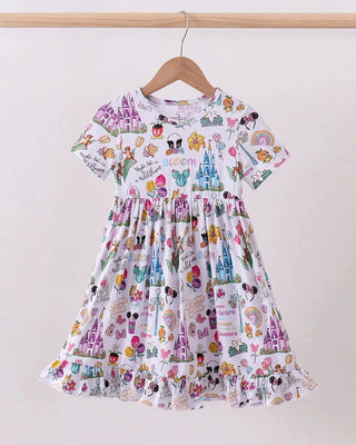 Children's dress with colorful patterns on a hanger against a white background