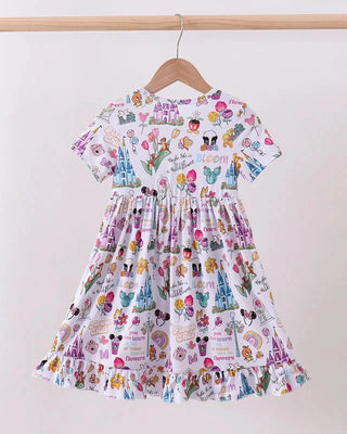 Colorful children's dress with cartoon character print on a hanger against a white background
