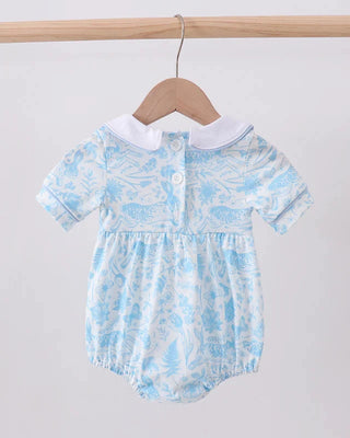 Baby romper with blue floral pattern on a wooden hanger against a white background