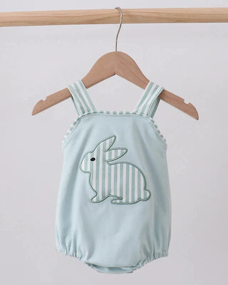 Light blue baby romper with bunny design on a wooden hanger against a light gray background