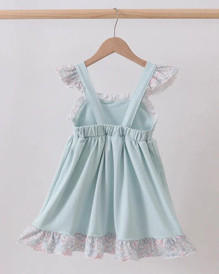 Light blue dress with lace details on a wooden hanger against a white background