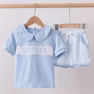 Children's blue outfit with 'BROTHER' text on a hanger against a light background