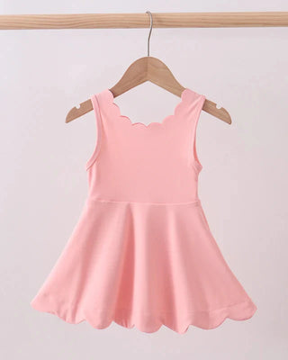 Pink dress on a hanger against a light gray background