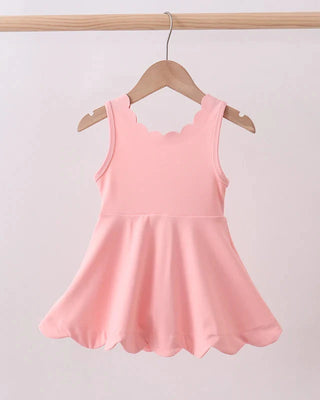 Pink dress on a hanger against a plain background