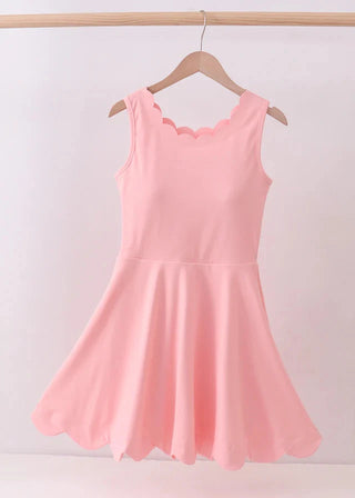 Pink sleeveless dress on a wooden hanger against a white background