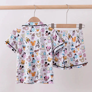 Children's pajama set with cartoon character print on a hanger against a white background