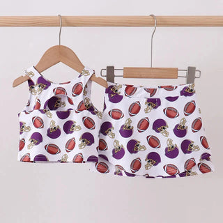 Children's tank top and skort set with football pattern on hangers against a white background