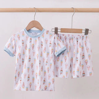 Children's pajama set with ice cream pattern on hangers against a white background