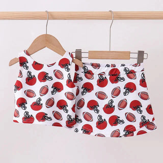 Red and black football  patterned skort outfit on a wooden hanger against a white background