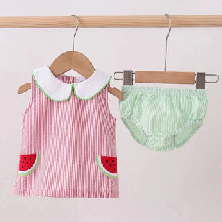 Baby’s red and green outfit with watermelon design on a white background