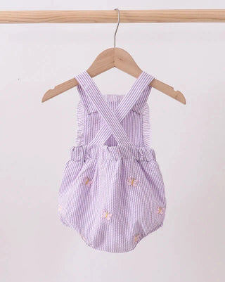 Purple striped baby romper with floral embroidery on a wooden hanger against a white background