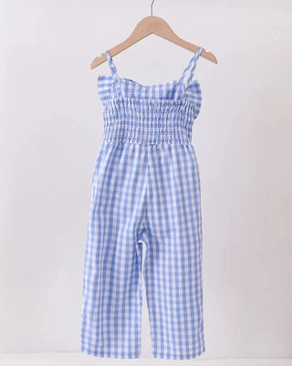 Blue and white checkered jumpsuit on a hanger against a white background