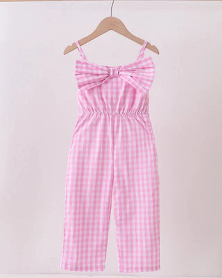 Pink checkered jumpsuit on a hanger against a white background