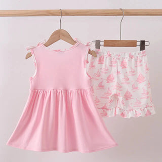 Pink top and shorts set hanging on a rack against a light gray background