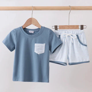 Children's blue t-shirt and shorts set on hangers against a white background