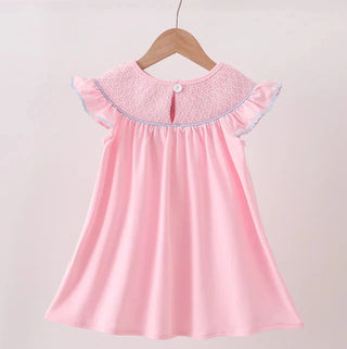 Pink dress with lace collar on a wooden hanger against a light background