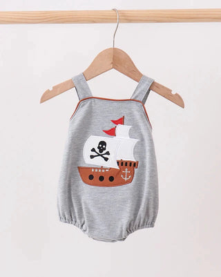 Gray baby romper with pirate ship design on a hanger against a white background