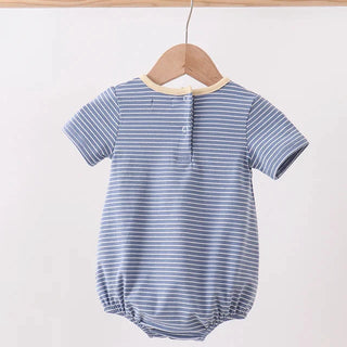 Blue and white striped baby romper on a wooden hanger against a light background