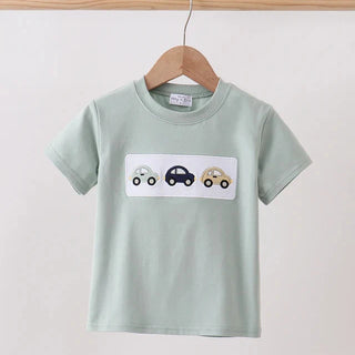 Light green t-shirt with car design on a wooden hanger against a white background