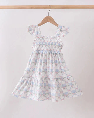 Floral dress on a hanger against a plain background