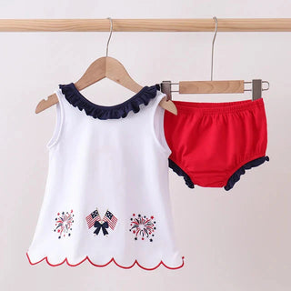 White sleeveless top with navy trim and red bloomers on hangers against a white background
