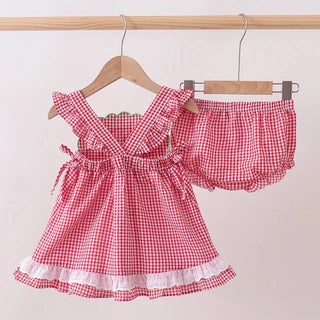 Red and white checkered top with matching bloomers on a hanger against a beige background