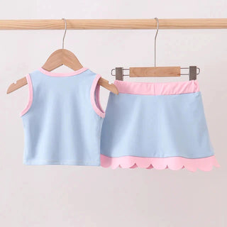 Light blue tank top and skirt set with pink trim on hangers against a light gray background