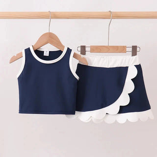Navy blue top and shorts set with white trim on hangers against a light gray background