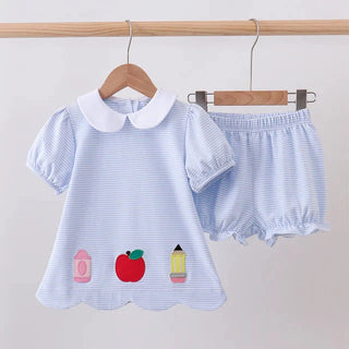 A baby girl's two-piece outfit set consisting of a light blue and white striped short-sleeve top with a white Peter Pan collar and three small school-themed appliques, paired with matching light blue and white striped bloomers, hanging on wooden hangers.