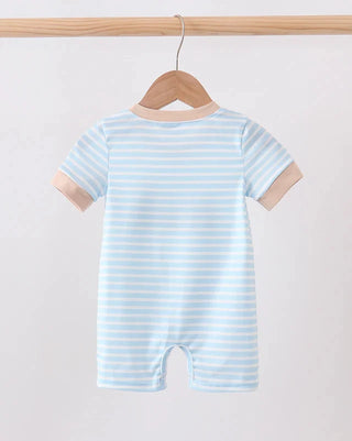 A baby short-sleeve romper hanging on a wooden hanger from a wooden clothes rack. The romper features light blue and white horizontal stripes with solid beige cuffs and a beige crew neck.