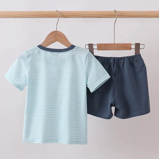 Children's striped shirt and shorts set hanging on a rack against a plain background