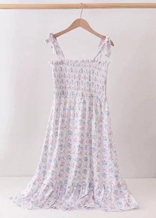 Floral dress on a hanger against a white background