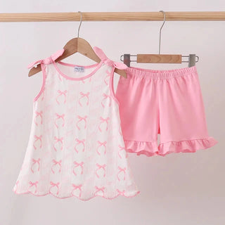 White Top with pink bows and pink shorts on hangers against a white background