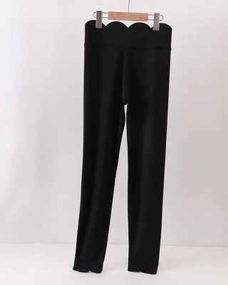Black pants on a hanger against a white background