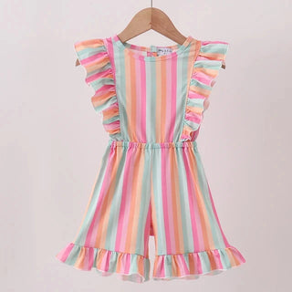 A children's sleeveless romper with ruffled cap sleeves and a ruffled hem, featuring vertical pastel stripes in pink, orange, yellow, green, and blue. It is shown hanging on a wooden hanger against a plain light background.