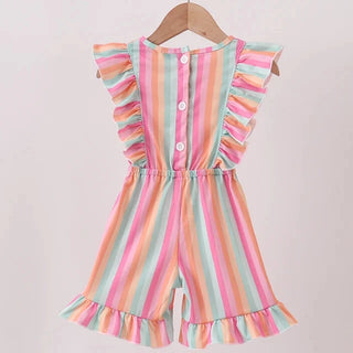 A children's sleeveless romper with ruffled shoulders and hem, featuring vertical pastel stripes in pink, orange, yellow, green, and blue, hanging on a wooden hanger against a light background.