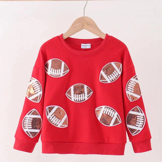 A red long-sleeve sweatshirt with a football print pattern, hanging on a wooden hanger against a plain light background.