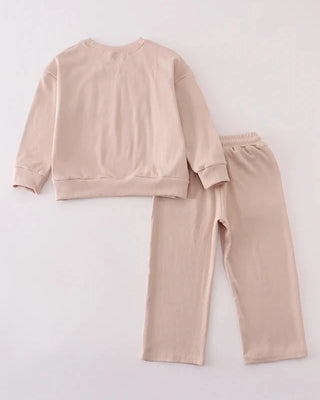 Beige pajama set on a light gray background