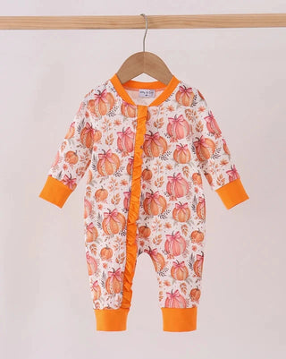 A baby long-sleeve footless romper hanging on a wooden hanger, featuring an orange and pink pumpkin print on a white background with orange trim.