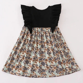 Dress with black ruffled top and patterned skirt on a white background