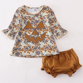 Children's outfit with patterned top and brown bloomers on a white background