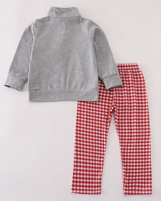 Gray fleece jacket and red gingham pants on a light gray background