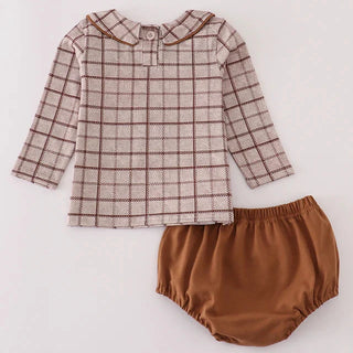 Children's outfit with checkered shirt and brown bloomers on a white background