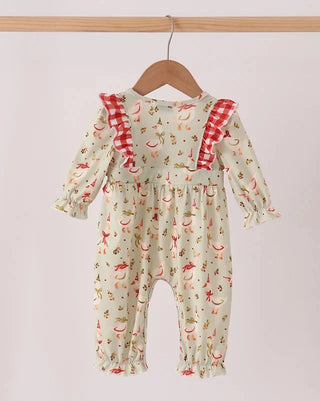 A baby long-sleeve romper in a light cream color with a red and orange animal print, featuring red-and-white gingham shoulder straps, hanging on a wooden hanger.