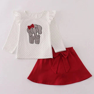 Children's outfit with white top featuring an elephant design and red skirt on a light gray background