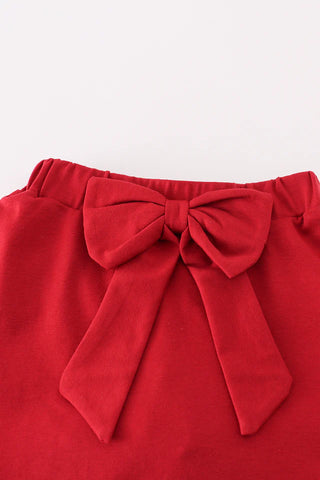 Red skirt with a large bow on a white background